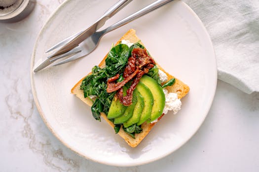 Savor this healthy avocado and spinach toast served on a marble table, perfect for breakfast.